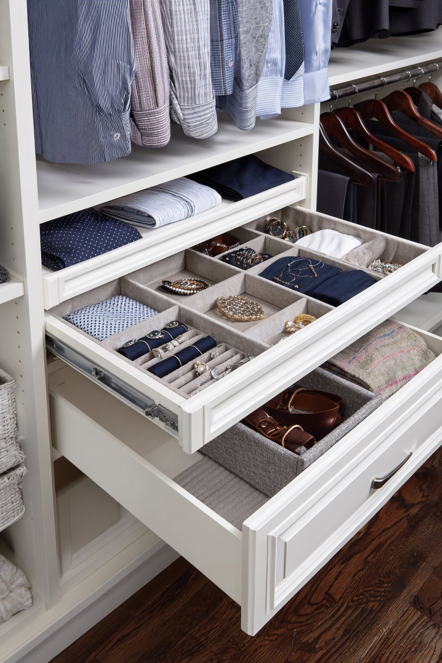 White melamine closet with pull-out jewelry tray, tie and belt rack, hamper basket and motion-sensor lighting