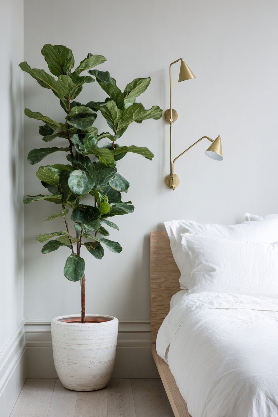 Scandinavian small bedroom with ash wood platform bed and wall-mounted brass reading lights