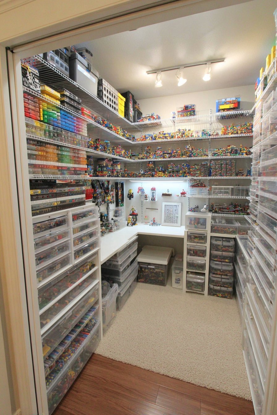 Reach-in closet turned Lego storage with white wire shelves, clear drawers, fold-down desk and magnetic door tins