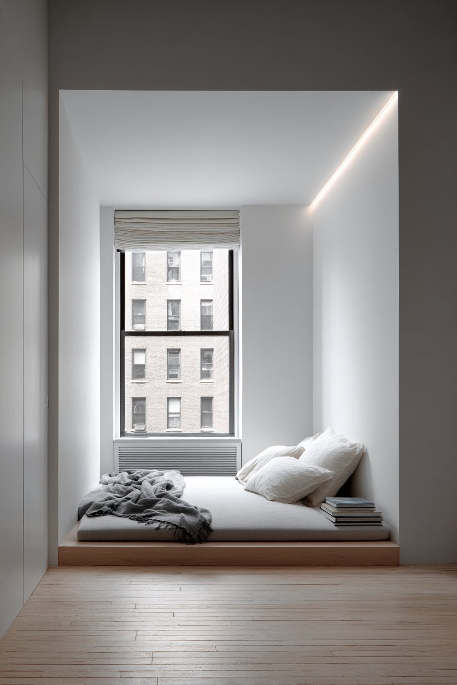 Upholstered grey sleeping alcove with white bedding, recessed LED strip and pale ash floor