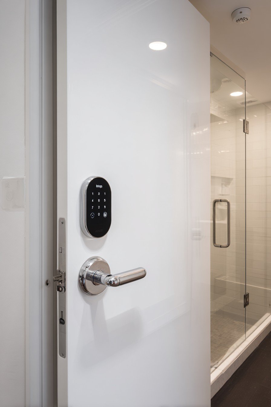 White lacquer flush bedroom door with keypad lock and LED status lights in a smart-home bedroom