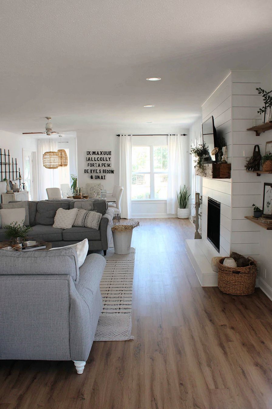 Modern farmhouse living room with black sliding barn door wall, vintage farm tools and white shiplap accent