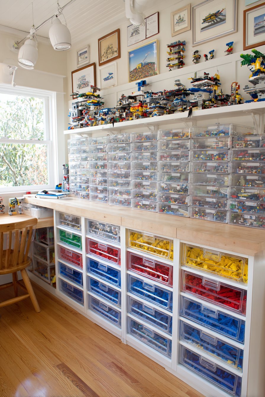 Counter-top unit of 40 clear small drawers holding Lego sorted by color and type with shelves of builds above