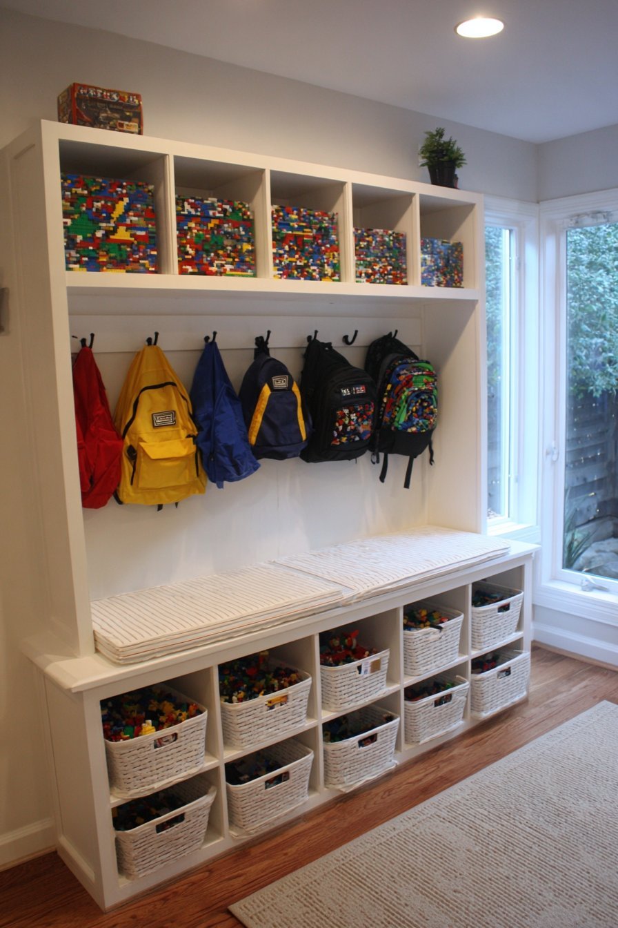 White built-in mudroom bench with lift-up seat, pull-out Lego bins on casters and fabric basket cubbies