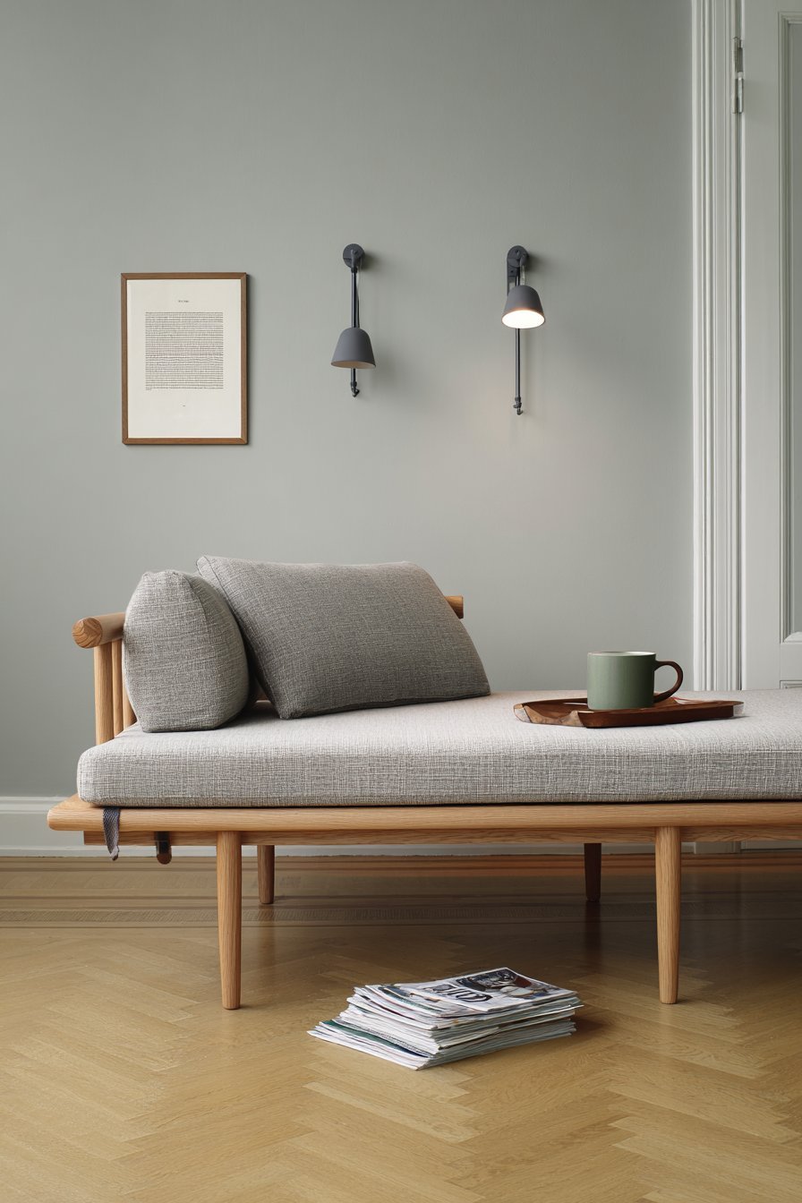 White-washed oak daybed with canvas cushions, adjustable wall reading lights and ash side table